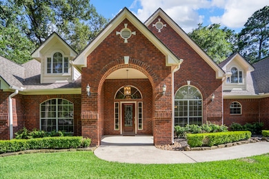A deep brick archway and soaring gables frame the