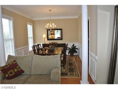 Dining Room - Hardwood floor, crown molding, wains