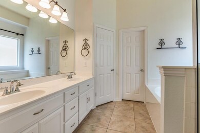 Bathroom with tile patterned flooring, a washtub, 