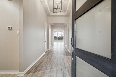 This is a modern hallway featuring neutral walls,