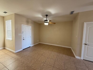 Unfurnished room featuring ceiling fan and light tile patterned flooring