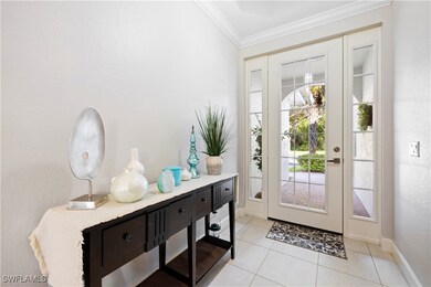 Doorway to outside with crown molding, light tile patterned floors, and a textured wall
