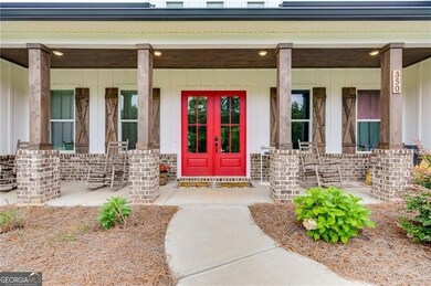 Doorway to property featuring covered porch