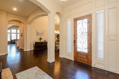 Roman styled arches upon entry and throughout this impeccable home.