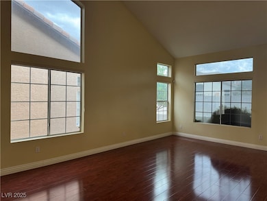 Unfurnished room with dark wood-style floors, high