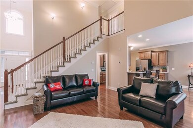 Hardwood floors flow perfectly through the living room, kitchen, & dining area