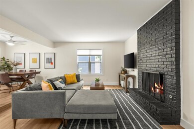 Living area featuring a ceiling fan, baseboards, 