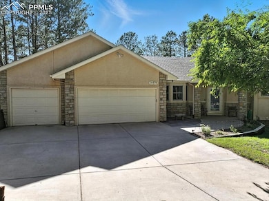 View of front facade with stone siding, a garage, stucco siding, concrete driveway, and a shingled roof