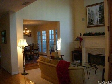 Soaring ceilings, wood beams, custom mantle, fireplace in the formal living room. Regal and warm. 