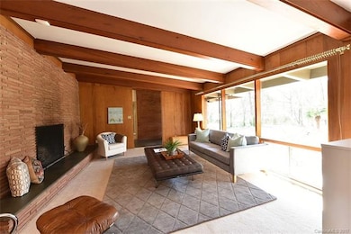 A view of the living rooms wood burning fireplace.