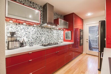 Kitchen with light wood-style floors, gas stoveto