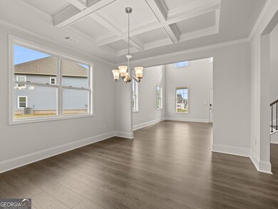 Westerly dining room with a window and open to the two-story foyer