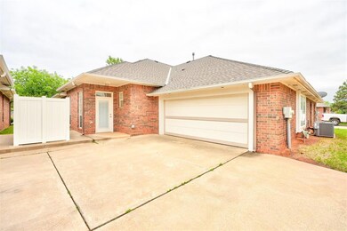 Single story home with a garage and central AC uni