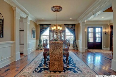 BEAUTIFULLY TRIMMED CASED OPENINGS ANCHOR THE VOLUME CEILINGS. OPEN FLOORPLAN WITH GREAT ATTENTION PAID TO EVERY DETAIL. ABUNDANT WOOD MOULDING AND HARDWOOD FLOORS.
