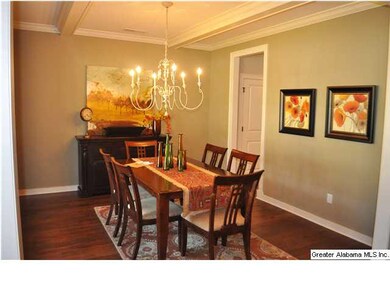 Formal dining area has hardwoods and exposed beams