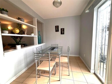 Tiled dining space with built in features and baseboards