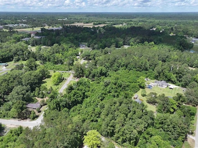 Birds eye view of property featuring a view of tre