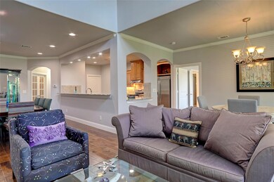 Arched openings, crown molding, and recessed light
