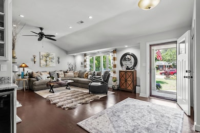 Living area featuring a ceiling fan, vaulted ceiling, dark wood-type flooring, wine cooler, and recessed lighting