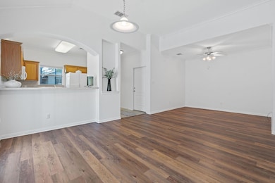 Living Room and Dining Room with views into the Kitchen and Entry Hall.
