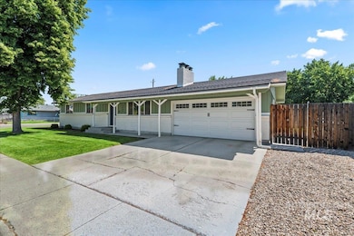 Single story home with a garage, driveway, and a chimney