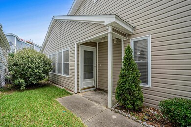 Doorway to property with a yard