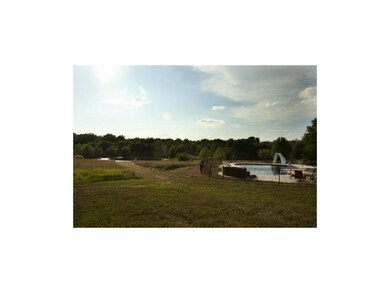 Walk out basement to pool overlooking property wit