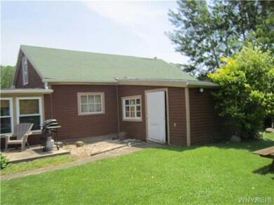 Garage. Back of Garage & patio area.  Stairs in ga