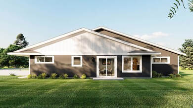 Rear view of property with a lawn