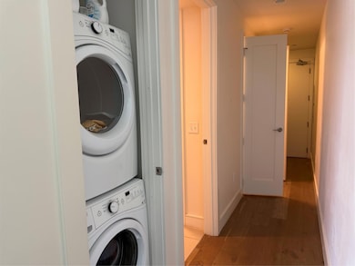Washroom with stacked washer / drying machine, li