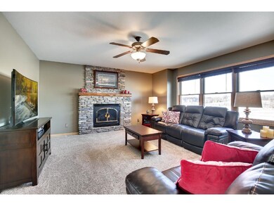 Living room has a wall of windows overlooking the 