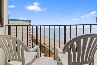 Balcony with a water view and a beach view