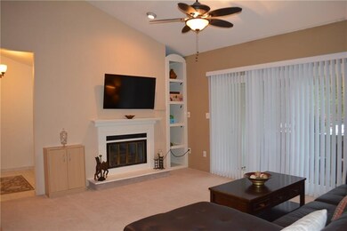 Living Room with wood burning fireplace and cathed