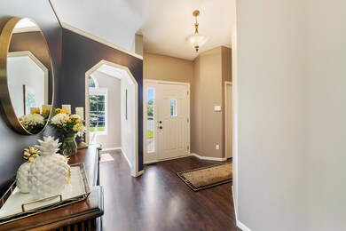 Spacious entry with access to garage, 1/2 bath, kitchen and dining area.