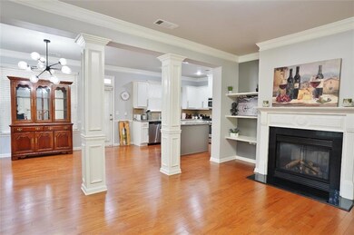Living area featuring ornamental molding, visible 