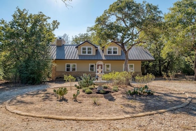 View of front facade with a metal roof, stone sid