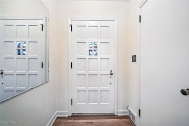 Entryway featuring wood finished floors and baseboards
