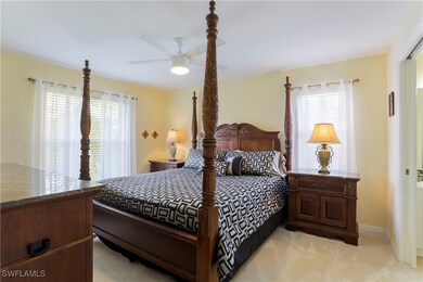 Bedroom with ceiling fan and light carpet