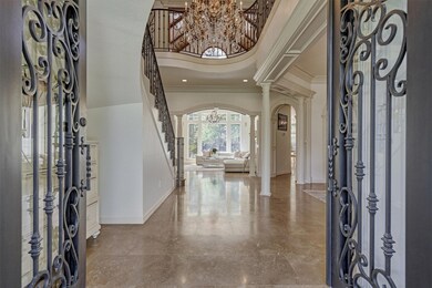 Enter through the custom wrought iron doors into the grand entry. Exquisite millwork, designer finishes & matte marble floors.
