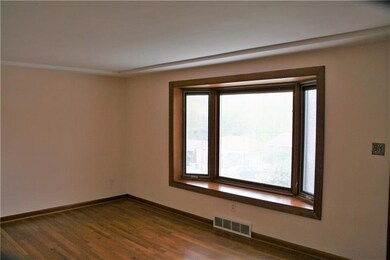 This living room vie highlights the bay window wit