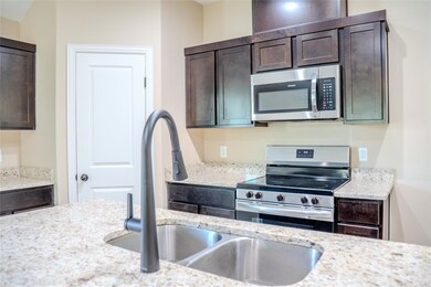 Kitchen featuring stainless steel appliances, dar