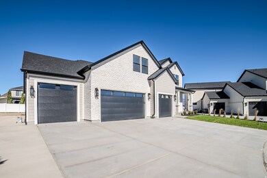 Modern farmhouse with driveway, roof with shingles, and a garage