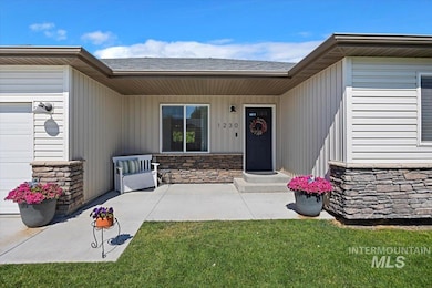 Property entrance featuring stone siding and roof with shingles
