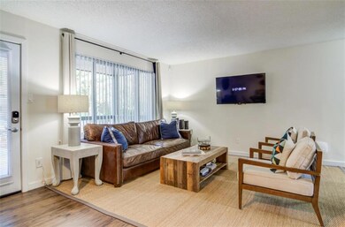 Living room with a textured ceiling and hardwood /