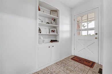 Front West Door Entryway with light tile floors an