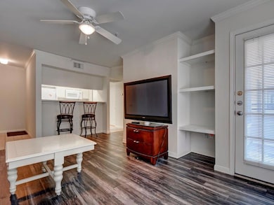 Living area featuring dark wood-type flooring, ce