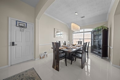 This dining room has a bright atmosphere with natural light from a large window