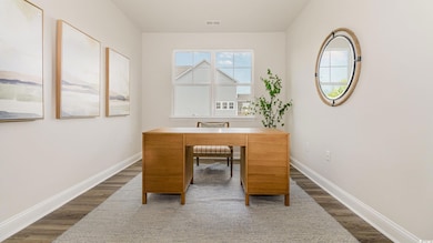 Office area with dark wood finished floors and baseboards