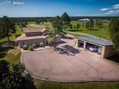 View showing front of Barn apartment door .entrance as well as steel building with extra parking and hay storage