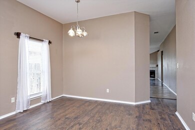 Spare room featuring a chandelier, wood finished 
